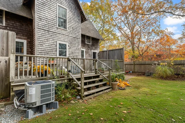 a backyard of a house with barbeque oven table and chairs