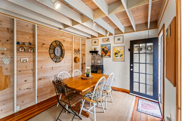 a view of a dining room with furniture and a large window