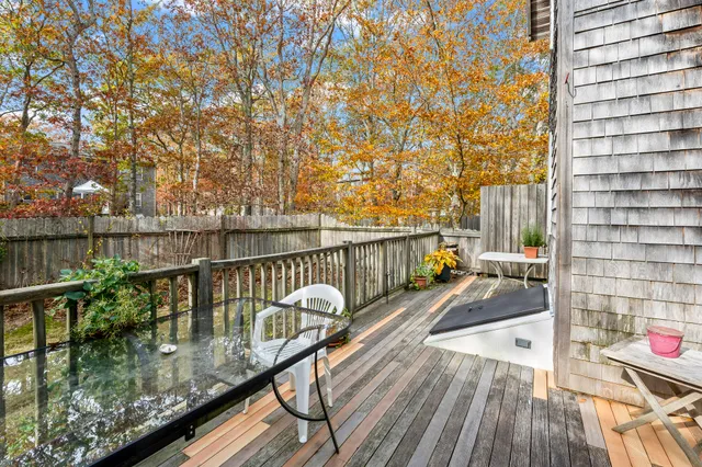 a view of balcony with wooden floor and seating space