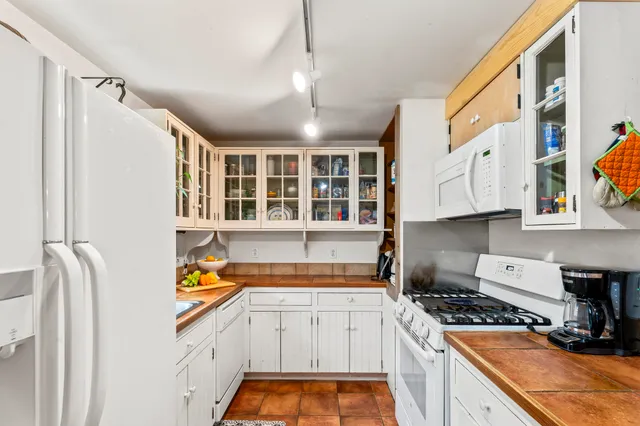a kitchen with stainless steel appliances granite countertop a stove and a sink