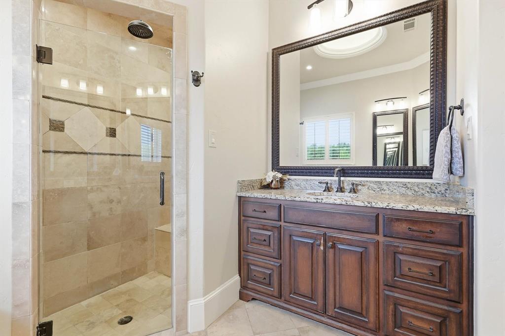 476 Hidden Valley Lane Coppell, TX 75019 - Photo 16 of 40 a bathroom with a granite countertop sink a mirror and a shower