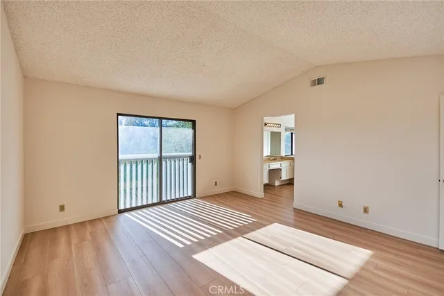 a view of a room with wooden floor and cabinet