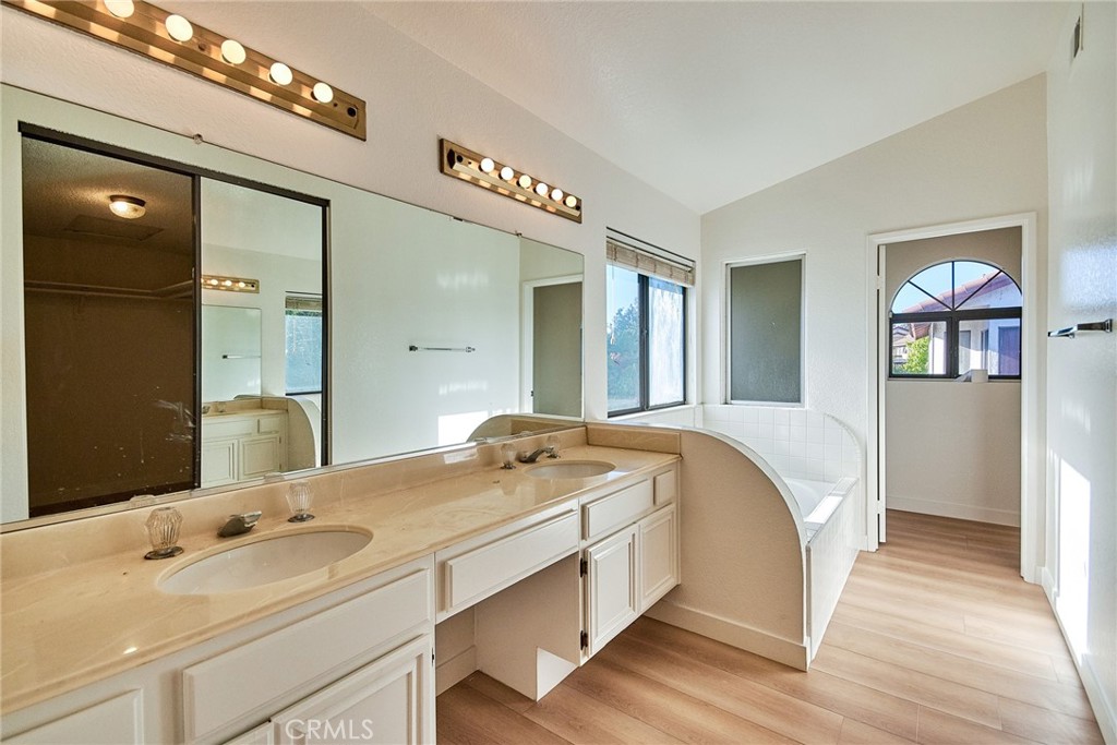 24352 East Rimford Place Diamond Bar, CA 91765 - Photo 20 of 31 a spacious bedroom with a bed and a chandelier