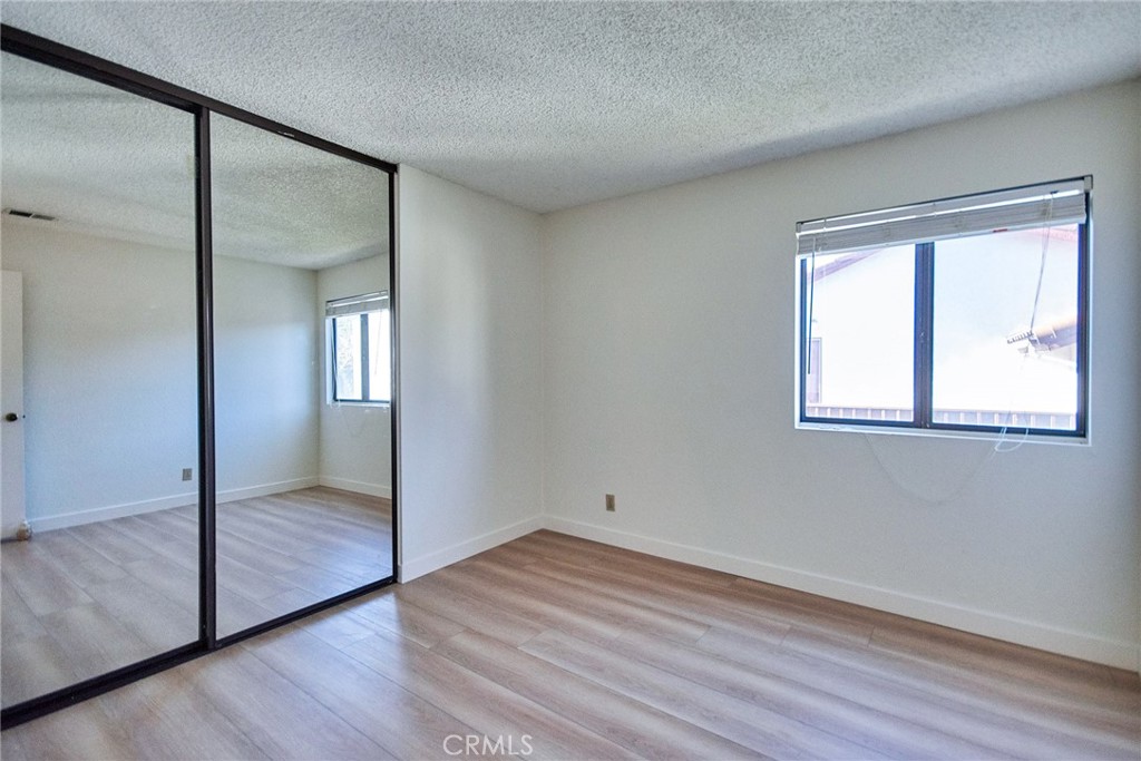 24352 East Rimford Place Diamond Bar, CA 91765 - Photo 23 of 31 an empty room with wooden floor mirror and windows