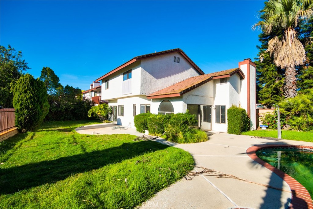 24352 East Rimford Place Diamond Bar, CA 91765 - Photo 29 of 31 a view of a white house with a big yard and potted plants