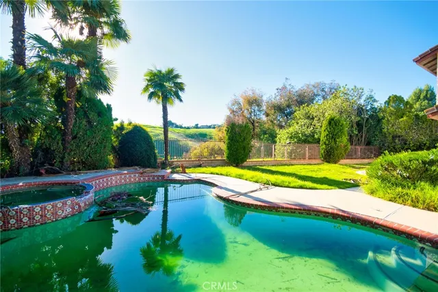 a view of a house with swimming pool and yard