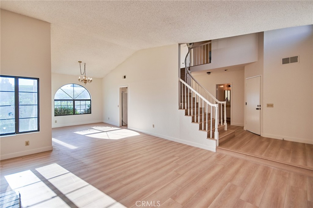 24352 East Rimford Place Diamond Bar, CA 91765 - Photo 5 of 31 a view of a hallway with wooden floor and dining room