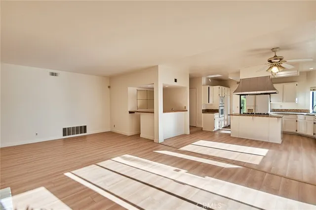 a view of a kitchen with furniture and refrigerator