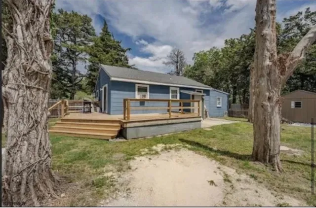 a kitchen with stainless steel appliances a sink a counter top space cabinets and a window