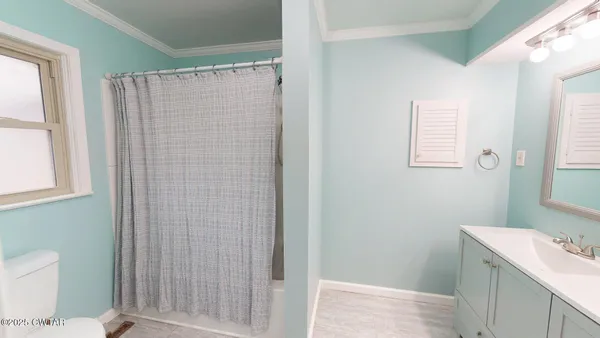 a bathroom with a shower and a toilet