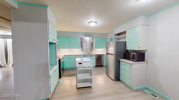 a kitchen with cabinets and refrigerator