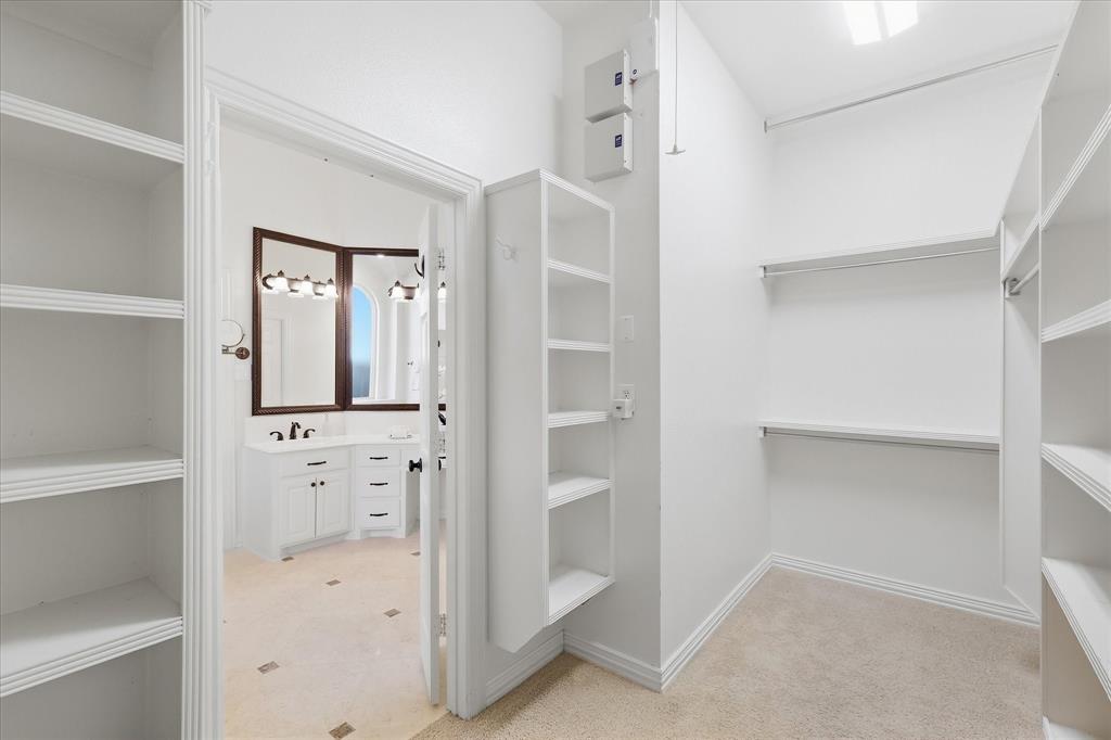 1447 Falls Road Coppell, TX 75019 - Photo 22 of 39 One Part of the Primary Bedroom's HUGE Closet