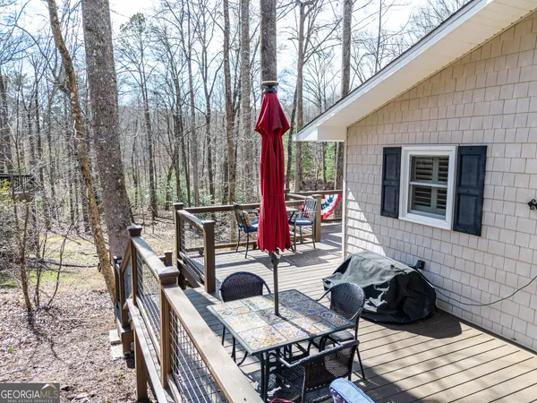 an outdoor sitting area with furniture and wooden floor