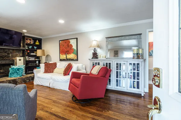 a living room with furniture and wooden floor
