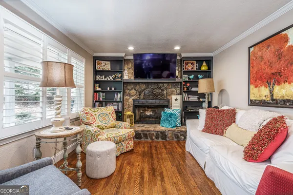 a living room with furniture and a fireplace