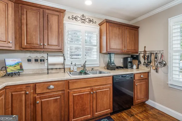 a kitchen with stainless steel appliances granite countertop a sink a stove and cabinets