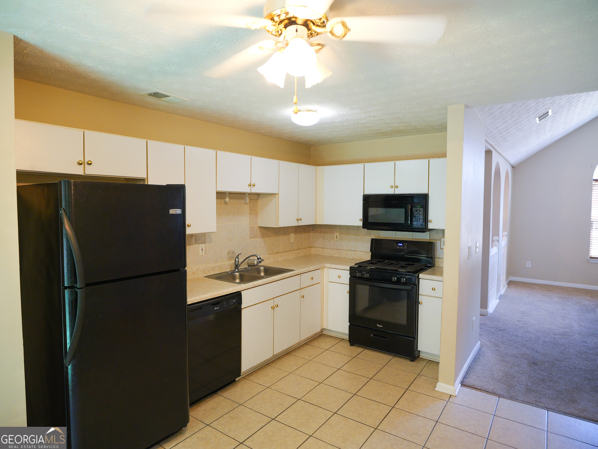 11036 Pebble Ridge Drive Hampton, GA 30228 - Photo 11 of 35 a kitchen with a refrigerator a sink and dishwasher