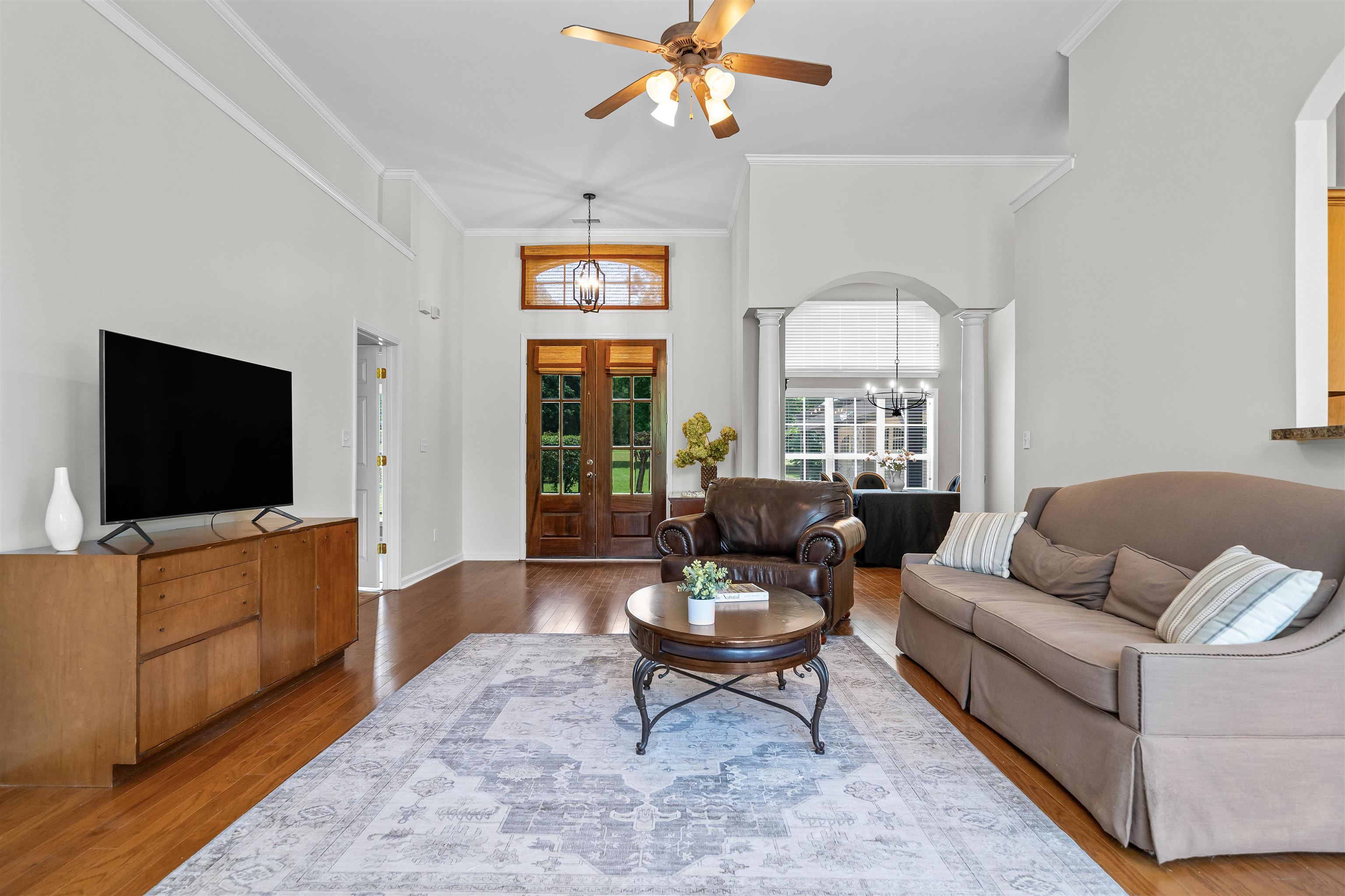 5035 Brian Ridge Road Arlington, TN 38002 - Photo 8 of 40 Spacious living area featuring high vaulted ceilings, warm wood-finish flooring, and a decorative ceiling fan