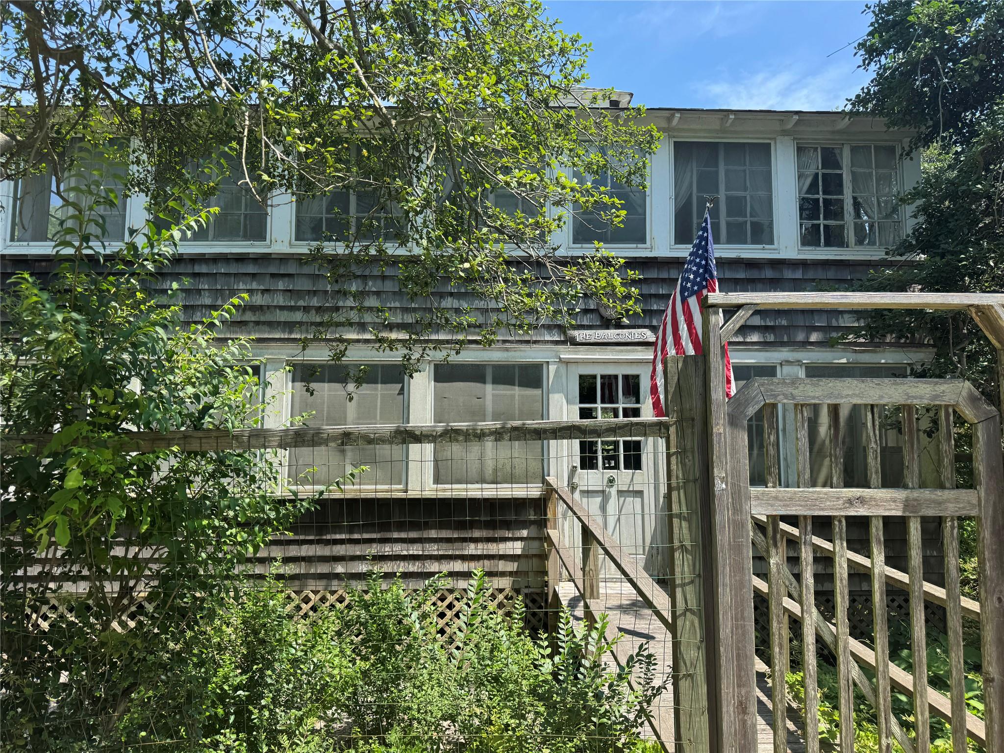 212 Wilmot Road Ocean Beach, NY 11770 - Photo 1 of 1 a view of a house with a small yard and potted plants