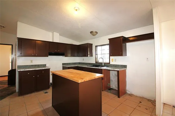 a kitchen with stainless steel appliances a sink and a refrigerator