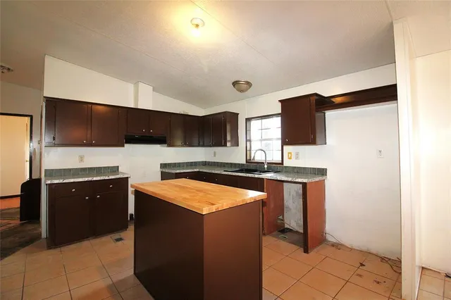 a kitchen with stainless steel appliances a sink and a refrigerator