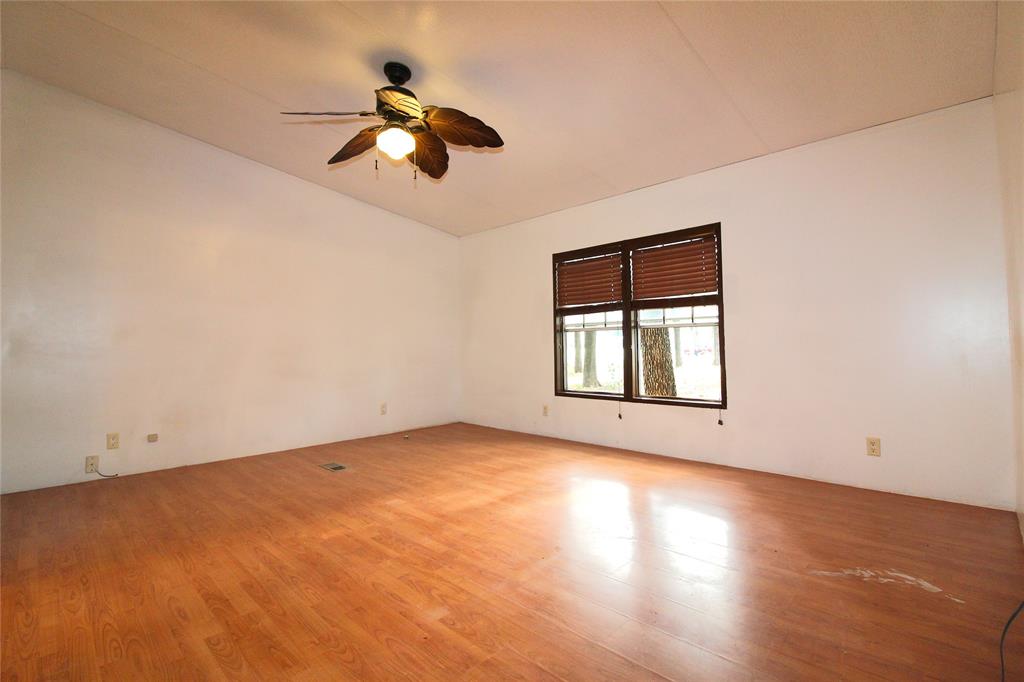 5199 Timarron Drive Scurry, TX 75158 - Photo 15 of 29 an empty room with a window and a ceiling fan
