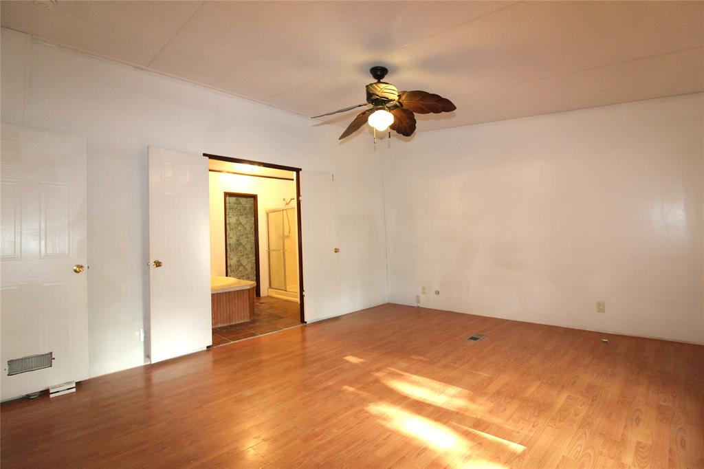 5199 Timarron Drive Scurry, TX 75158 - Photo 16 of 29 a view of a big room with wooden floor and windows