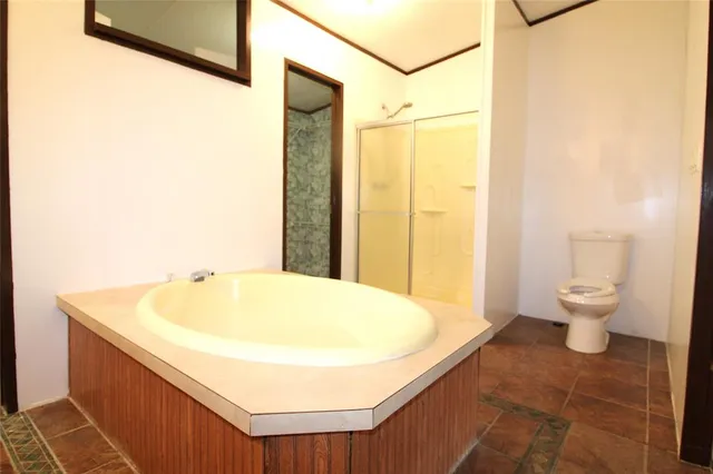 a bathroom with a tub and shower