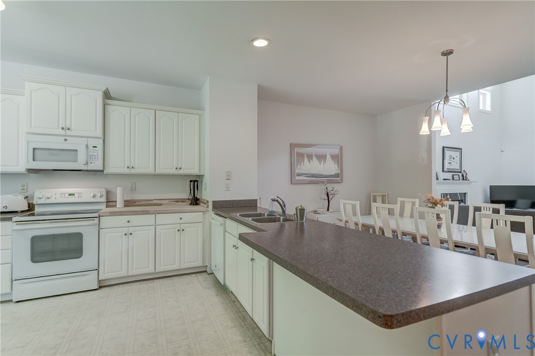 7902 Johnson Road Petersburg, VA 23805 - Photo 10 of 55 Kitchen featuring white cabinetry with brushed nic