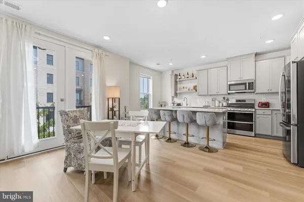 a view of kitchen with microwave stove top oven and cabinets