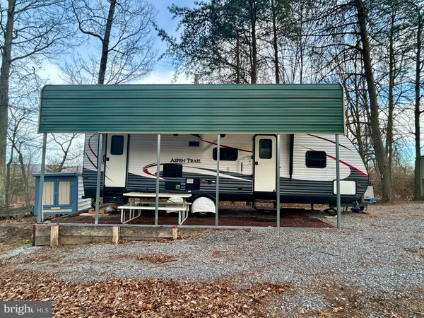 a backyard of a house with barbeque oven and outdoor seating