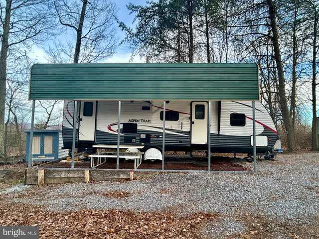 a backyard of a house with barbeque oven and outdoor seating