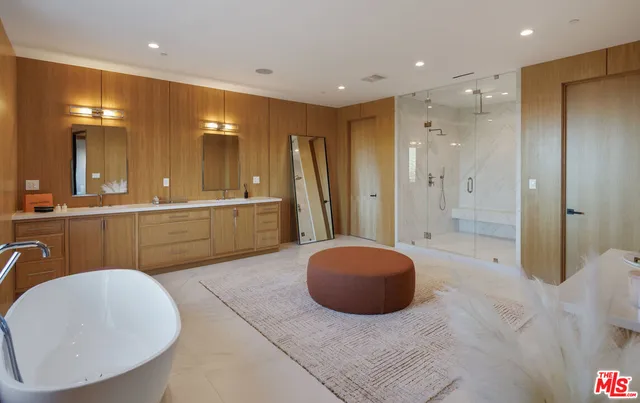 a spacious bathroom with a large tub and shower