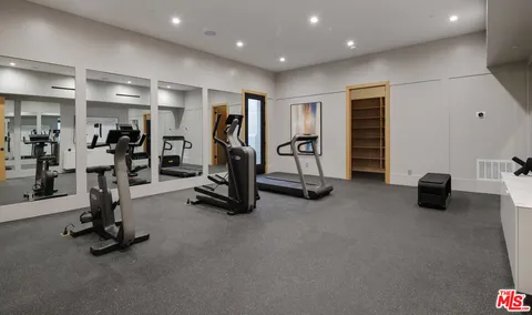 a view of a house with pool and sitting area