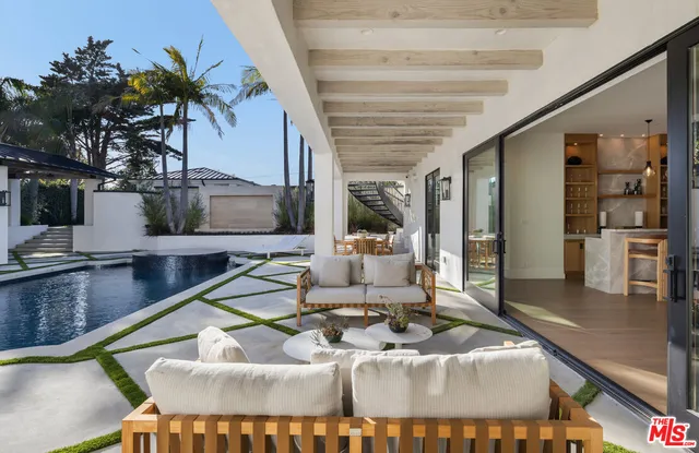 a living room with furniture and large windows