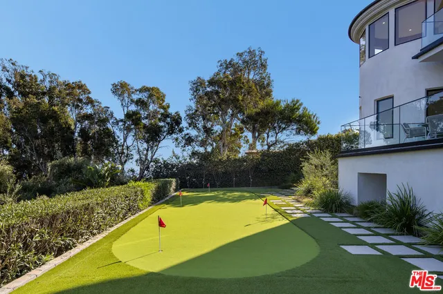 a view of a swimming pool with a yard