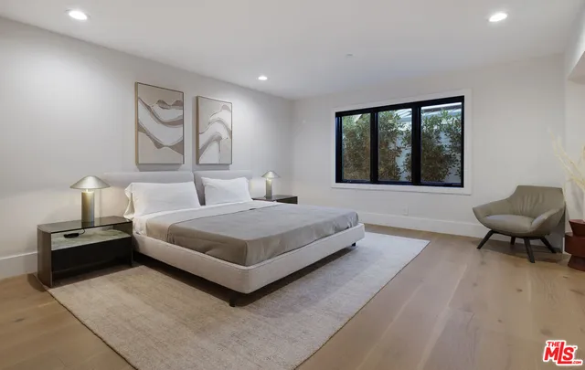 a spacious bedroom with a bed and furniture