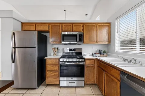 a kitchen with a stove sink and refrigerator