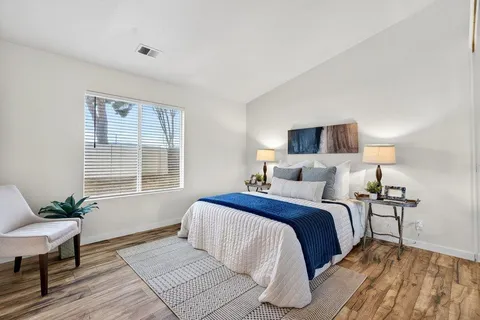 a bed room with a bed and a chair