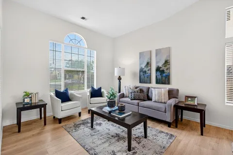a living room with furniture a rug and a large window