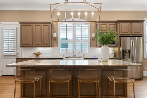 a kitchen with stainless steel appliances granite countertop a sink and wooden cabinets