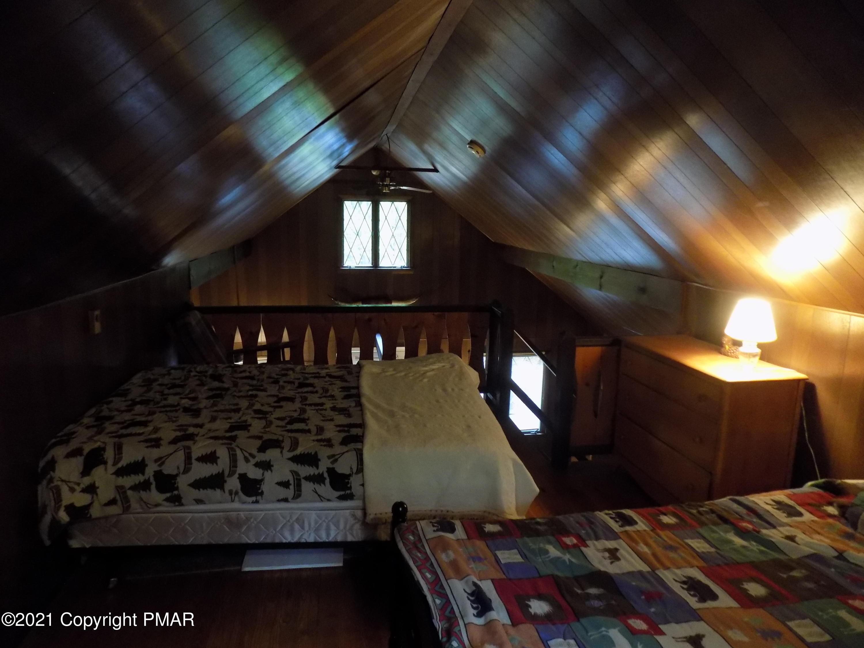 60 Buckhill Road Albrightsville, PA 18210 - Photo 11 of 13 a bed sitting in a bedroom next to a lamp