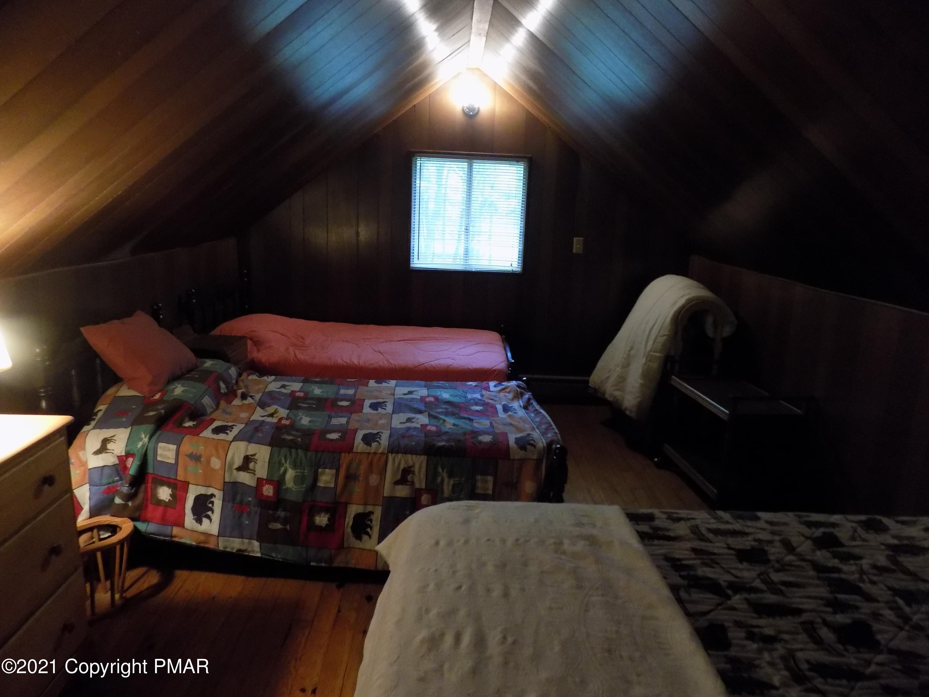 60 Buckhill Road Albrightsville, PA 18210 - Photo 10 of 13 a bedroom with a bed next to a window with outer view