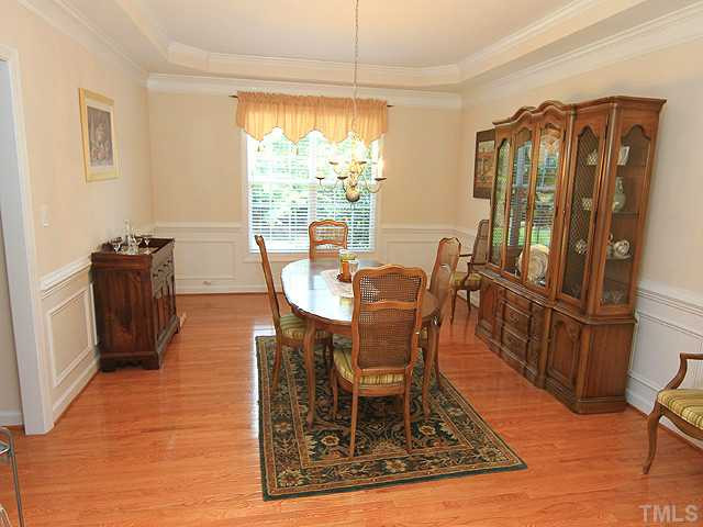 10537 Swerling Way Raleigh, NC 27614 - Photo 3 of 12 Formal dining room with wainscotting, crown molding, trey ceiling, and hardwoods. Dining Room