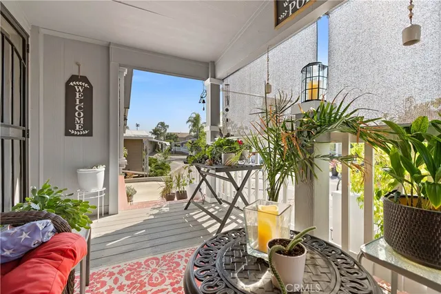 a living room with furniture and kitchen view