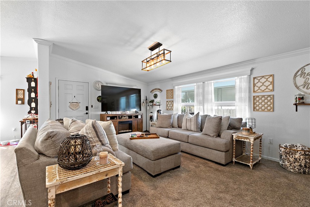 8651 Foothill Boulevard, Unit 82 Rancho Cucamonga, CA 91730 - Photo 16 of 56 a living room with furniture and a flat screen tv