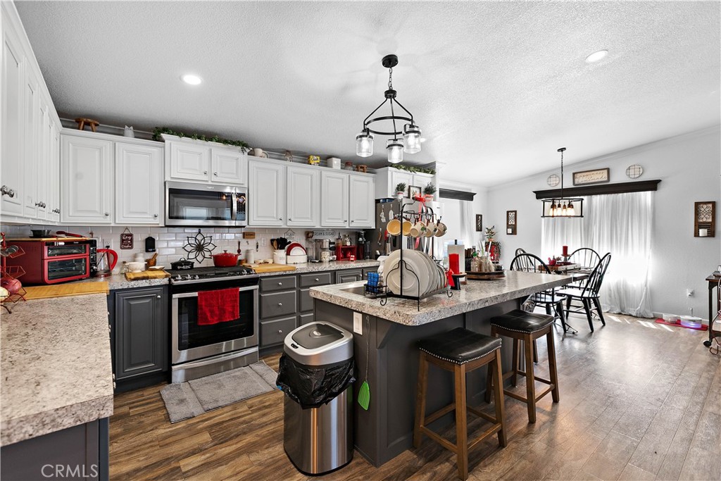 8651 Foothill Boulevard, Unit 82 Rancho Cucamonga, CA 91730 - Photo 22 of 56 a view of a kitchen and dining area with wooden floor