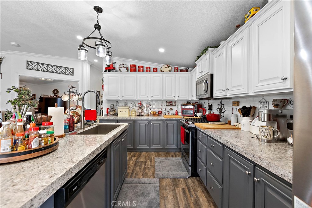 8651 Foothill Boulevard, Unit 82 Rancho Cucamonga, CA 91730 - Photo 24 of 56 a kitchen with lots of counter top space and wooden floor