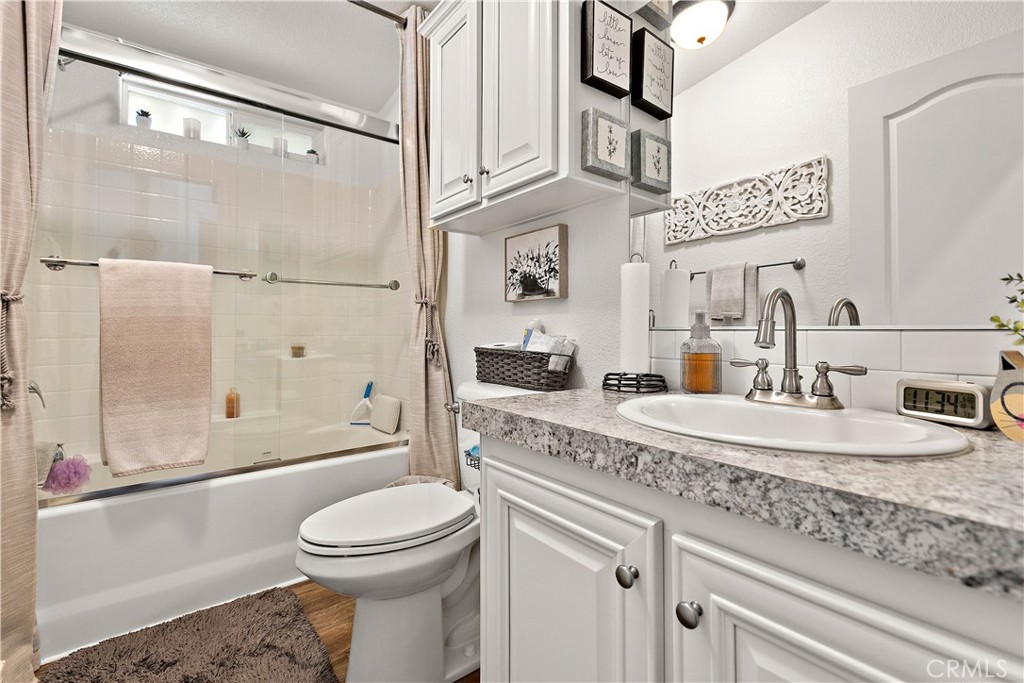 8651 Foothill Boulevard, Unit 82 Rancho Cucamonga, CA 91730 - Photo 26 of 56 a bathroom with a granite countertop sink mirror vanity and toilet