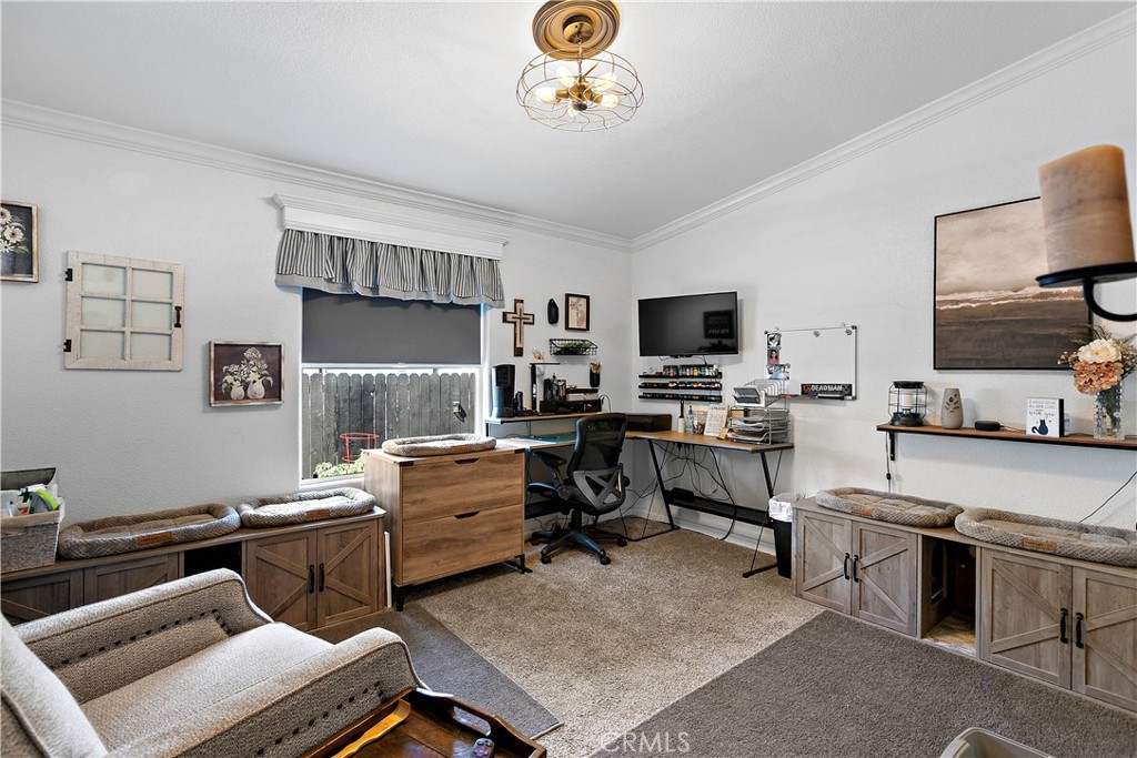8651 Foothill Boulevard, Unit 82 Rancho Cucamonga, CA 91730 - Photo 31 of 56 a work room with furniture a flat screen tv and a window